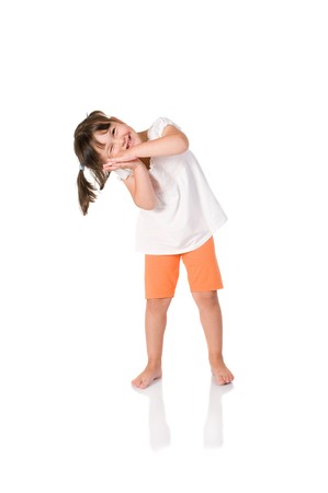 Little cute baby girl jokes to pretend to be sleeping isolated on white backgroundの写真素材