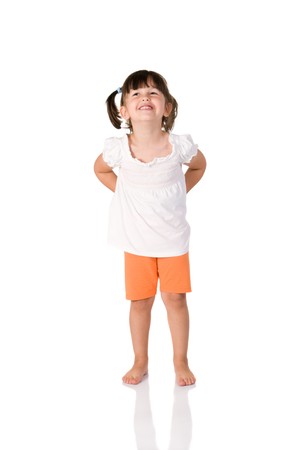 Little cute girl smirking at camera isolated on white backgroundの写真素材