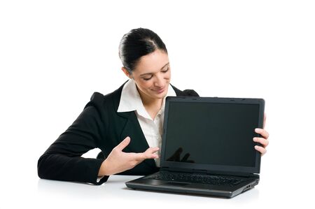 Young business woman showing blank laptop screen ready for your text and promotion, isolated on white background.の写真素材