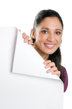 Beautiful smiling young woman looking down on a folded corner of a blank signboard to write it on whatever you want!の写真素材