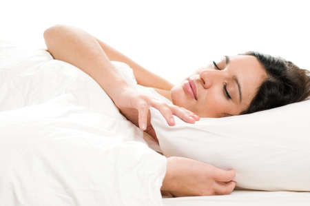 Beautiful young woman sleeping on white isolatedの写真素材
