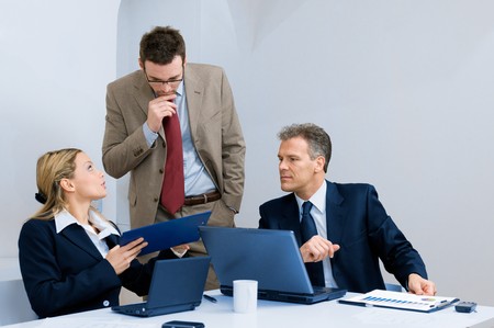 Modern business team discussing together their business strategy at meeting in officeの写真素材