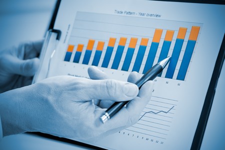 Businessman hand showing growing chart on annual report, good business growthの写真素材