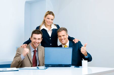 Happy successful bussiness team celebrate in their modern officeの写真素材