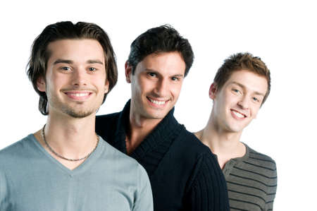 Three happy young men standing together and smiling isolated on white backgroundの写真素材