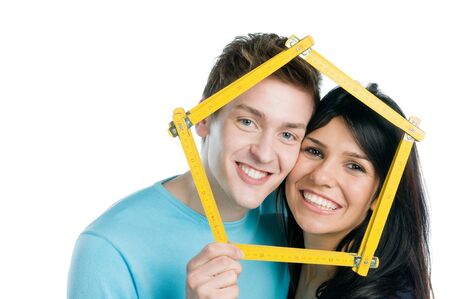 Happy young couple planning and desire their new home isolated on white backgroundの写真素材