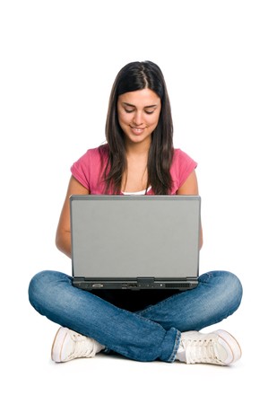 Happy smiling latin girl working on laptop isolated on white backgroundの写真素材