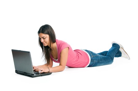 Happy young latin woman working absorbed at her laptop isolated on white backgroundの写真素材