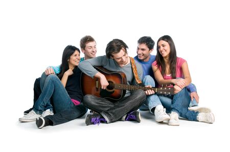 Happy young group of friends have fun and playing together the guitar isolated on white backgroundの写真素材