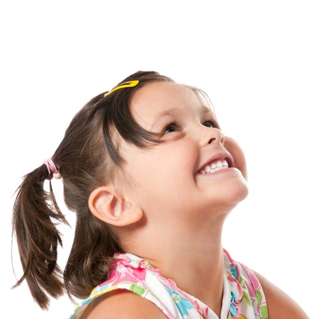 Smiling little child looking up at copyspace isolated on white backgroundの写真素材