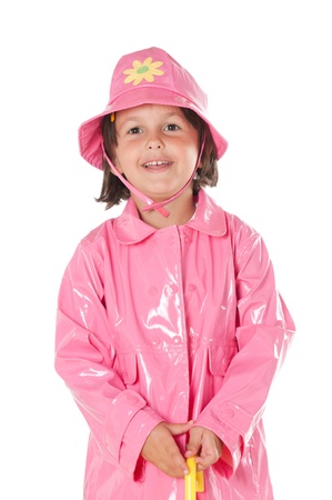 Happy smiling little girl with pink raincoat isolated on white backgroundの写真素材