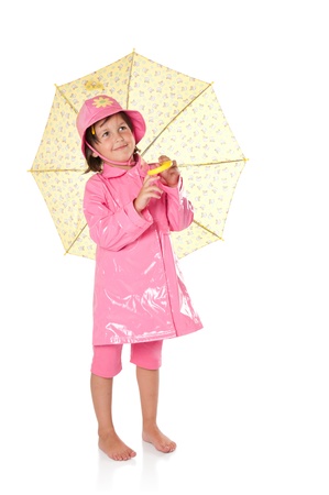 Happy little girl with raincoat and umbrella isolated on white backgroundの写真素材