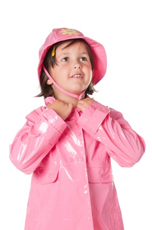 Happy little girl with pink raincoat isolated on white backgroundの写真素材