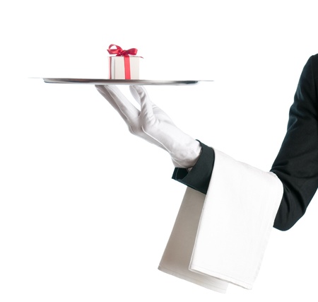 Waiter holding a tray with gift box for bithday or Christmas isolated on white backgroundの写真素材