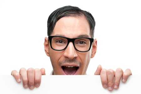 Surprised and shocked happy nerd holding white placard isolated on white backgroundの写真素材