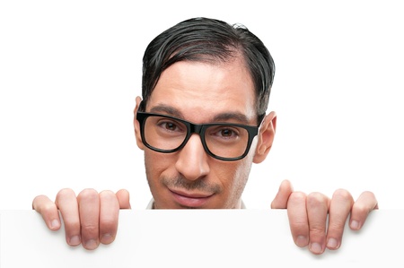Smiling nerd holding a placard isolated on white backgroundの写真素材
