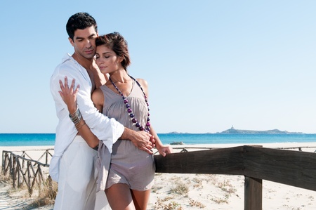 Sweet young couple flirting together at summer beachの写真素材