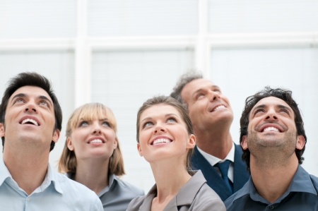 Happy positive business group looking up with dreaming expression Happy positive business group looking up with dreaming expression