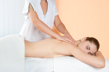 Relaxing hand massage on back at beauty spa salonの写真素材