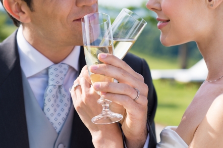 Closeup Of Bride And Groom Drinking Champagne Outdoorの写真素材