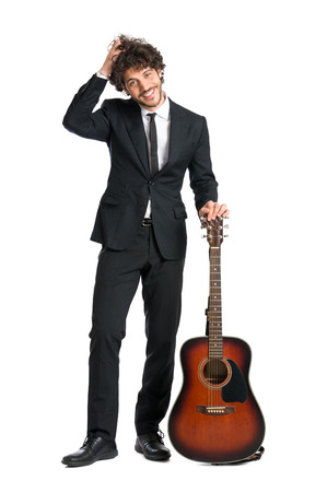 Portrait Of Happy Man Standing With Guitar Isolated On  White Backgroundの写真素材
