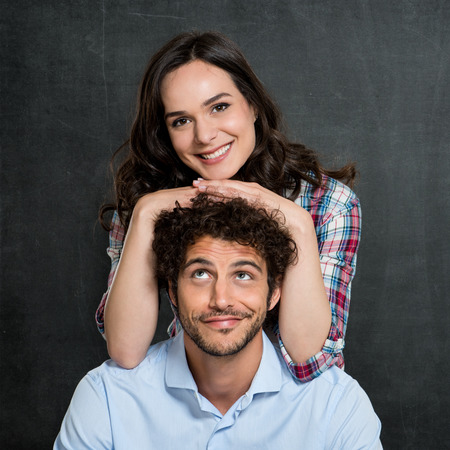 Man Looking At Happy Woman Leaning On His Headの写真素材