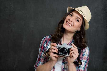 Happy Hipster Girl Holding Vintage Camera Isolated On Gray Backgroundの写真素材