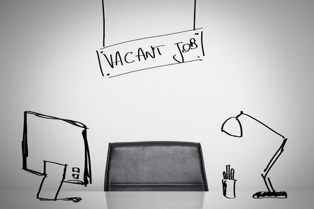 Vacant job business concept: a leather chair and an empty desk at officeの写真素材