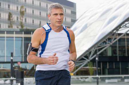 Portrait Of A Mature Male Athlete Jogging in the Cityの写真素材