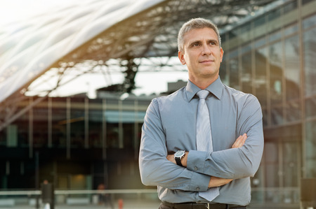Satisfied Businessman Daydreaming In Front Of A Business Buildingの写真素材