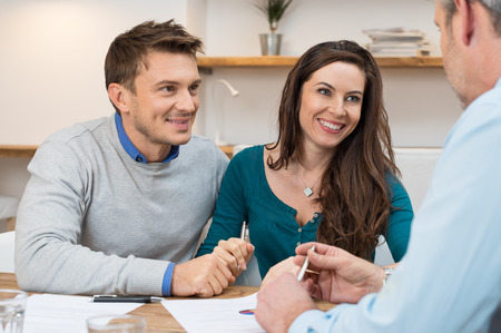 Young couple meeting financial advisor for investmentの写真素材