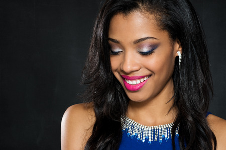 Beautiful young fashion woman wearing blue dress with makeup on faceの写真素材