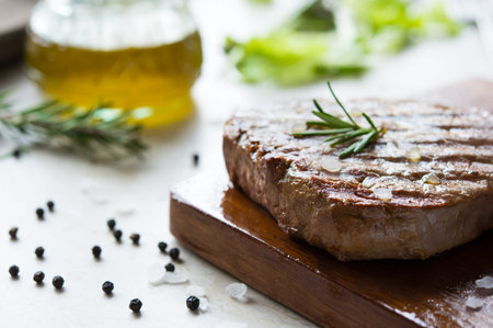 Grilled fillet steak on wooden cutting boardの写真素材