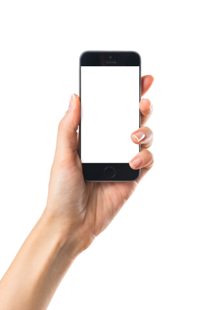 Closeup shot of a woman showing mobile phone isolated on white background. Female hand holding a modern smartphone. Hand showing a white phone's screen.の写真素材