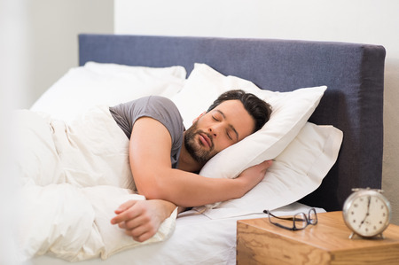Handsome man sleeping in his bedroom.の写真素材