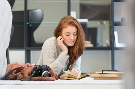 Portrait of a young woman reading a book.