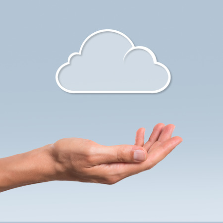 Female hand hold a cloud symbolyzing the cloud computing. Internet and cloud computing technology.の写真素材
