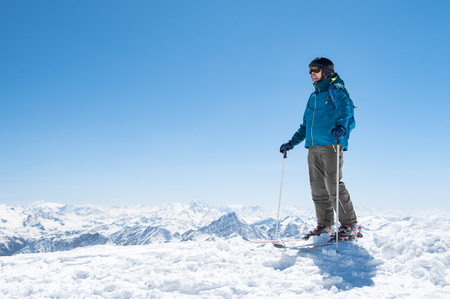 Young man ready for skiing on snowy mountain.の写真素材