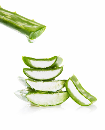 Close up of fresh aloe vera isolated on white background. Slices of green aloe with fresh drops of water or gel. Beauty treatment and healthy medicine concept.の写真素材