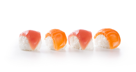 Delicious japanese cuisine, nigiri sushi with salmon and tuna isolated on white background. Closeup of four nigiri sushi in a row. Japanese fresh raw seafood sushi on white background. All you can eat.の写真素材