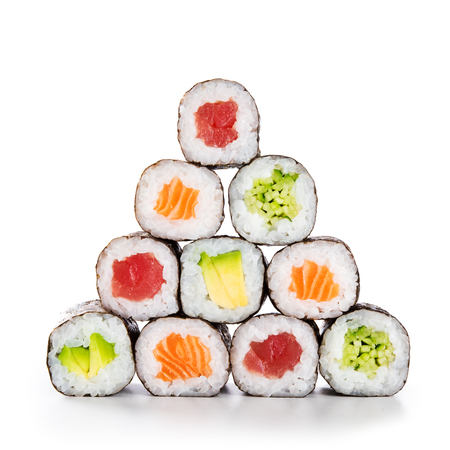 Fresh hosomaki in a pyramid isolated on white background. Sushi roll with salmon, tuna, avocado and cucumber. Traditional japanese food with maki. Delicious sushi pieces.