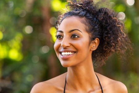 Smiling woman in swimsuit bikini looking away and smiling. Carefree young african american girl in...