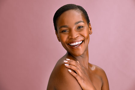 Happy young beauty woman feeling her soft skin after spa treatment.の写真素材