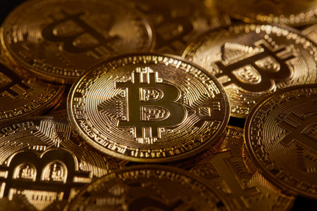 Golden ray of light illuminate bitcoin, the money of the future. Various bitcoin coins, symbol of new technology and economy. Btc cryptocurrency, new money and investment.の写真素材