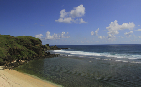 Green cliff with sea view and blue skyの写真素材