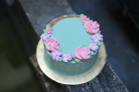 Blue buttercream birthday cake with pink and purple topingの写真素材