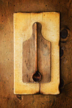 Old wood table with wooden spoons and boards in rustic vintage style. Top view. Retro concept.の写真素材