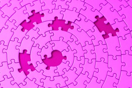 jigsaw in pink with five missing pieces - focus is on the center の写真素材