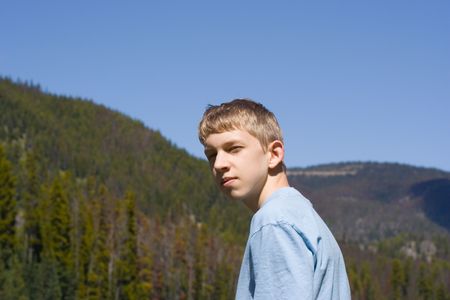 teenager irritated in front of a forest - looking cool の写真素材