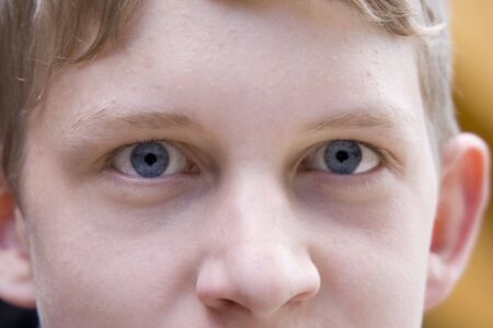 boy  with piercing glance - closeup -の写真素材